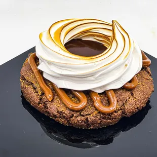 a chocolate cookie topped with whipped cream