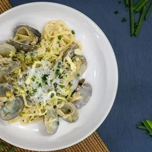 Inspired by the Korean dish Janchi Guksu, this hand-pulled pasta combines a creamy base with tender mussels and a delicate egg garnish