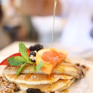 Pancakes with fried bananas and candied walnuts.