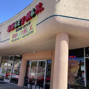 Outside, in the corner of the parking lot