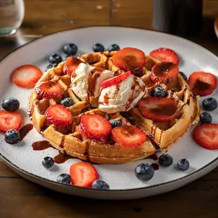 a waffle topped with strawberries and ice cream