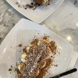 two plates of dessert on a marble table