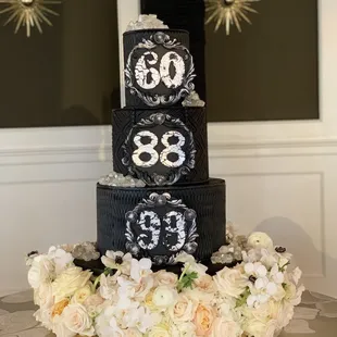 a three tiered cake decorated with flowers