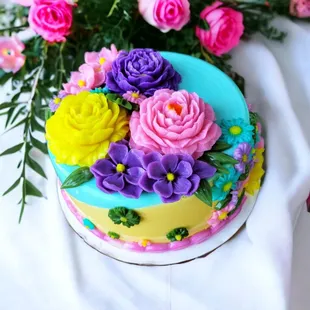 a colorful cake with flowers on top