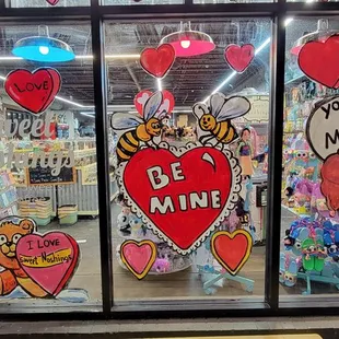 a store window decorated for valentine's day