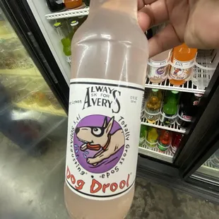 a person holding a bottle of alcohol