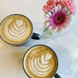 two cups of coffee with latte art