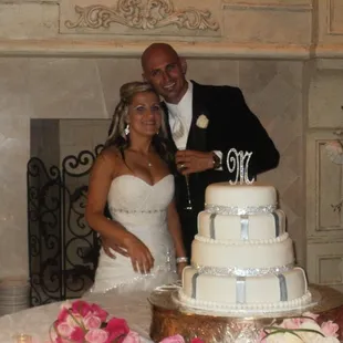 a bride and groom cutting their wedding cake