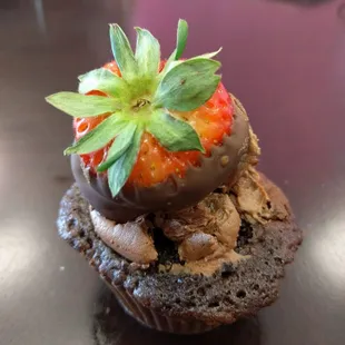 a chocolate cupcake with a strawberry on top