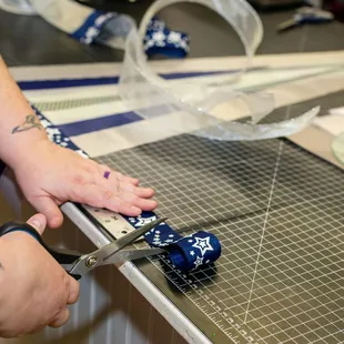 a person cutting fabric with scissors