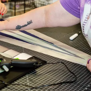 a woman cutting fabric with scissors