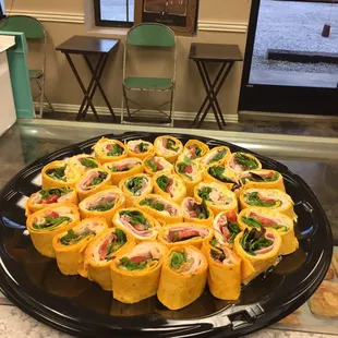 a platter of mini sandwiches