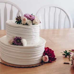 a white wedding cake with flowers