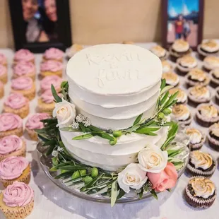 a wedding cake and cupcakes