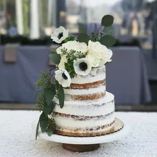 a naked cake with white flowers