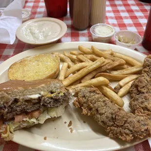 Cheeseburger and steak fingers with seasoned fries, garlic bread and gravy