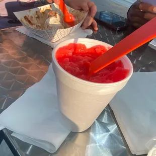 a woman eating a bowl of strawberry yogurt