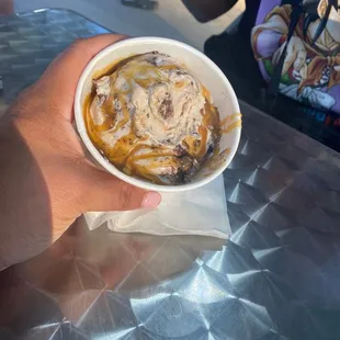 a person holding a bowl of ice cream