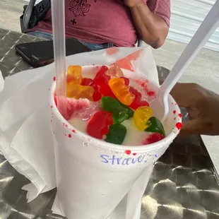 a man eating a bowl of gummy bears
