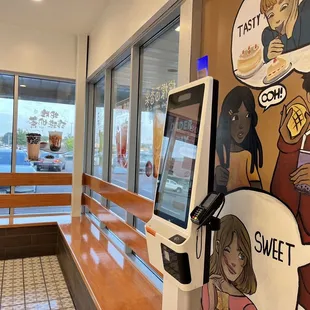 Self service station in front of an adorable mural