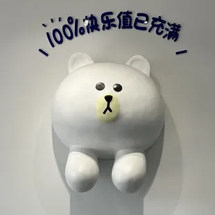 a white teddy bear on a wall