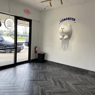 a large teddy bear on the wall