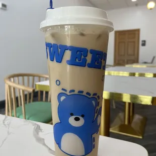 a cup of iced coffee with a blue bear on it