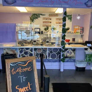 a sign in front of a bakery