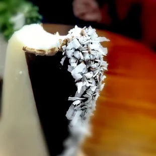 Coconut, filled with carmel, half dipped in chocolate, rolled in coconut.