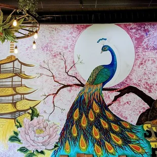 a mural of a peacock and a pagoda
