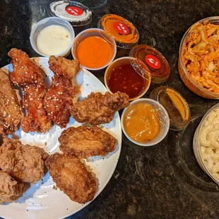 Chicken: Tenders (top), Thights (left), wings (bottom right)...
 Sauces galore...
 Kimchi slaw (top right)
 Macaroni Salad (bottom right)...