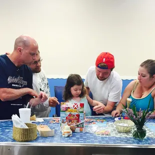 The whole family gathered to help their daughter finish the puzzle! And she did! Team work
