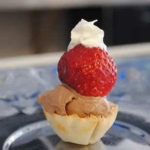 a strawberry on top of a cupcake