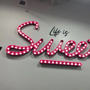 a neon sign that says life is sweet