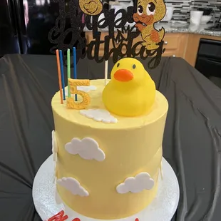 a birthday cake with a rubber duck