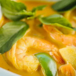 a bowl of soup with shrimp and vegetables