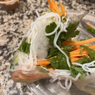 a clear plastic plate with a salad on it