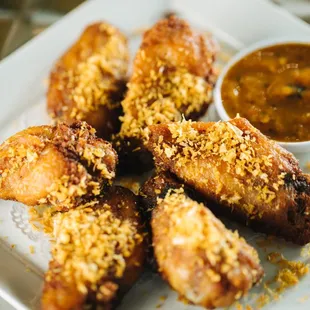 a plate of chicken wings with dipping sauce
