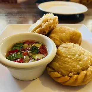 Curry Puff stuffed with ground chicken, potatoes and onions served with a sweet dipping sauce