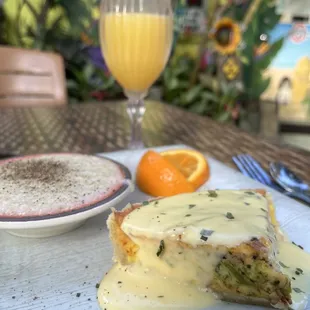 Ham and broccoli quiche with grits and a mimosa outside in the courtyard today!