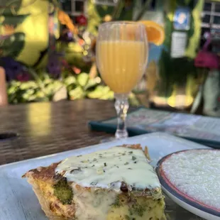 Ham and broccoli quiche, grits, and a mimosa