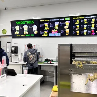 a man and a woman standing at a counter in a fast food restaurant