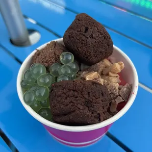 a cup of frozen yogurt with chocolate and fruit