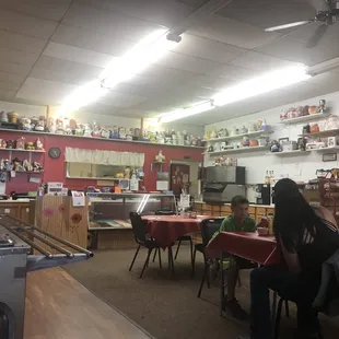 people sitting at tables in a store