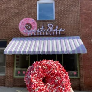 a hand holding a donut