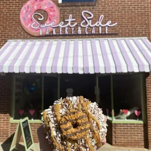 a hand holding a donut