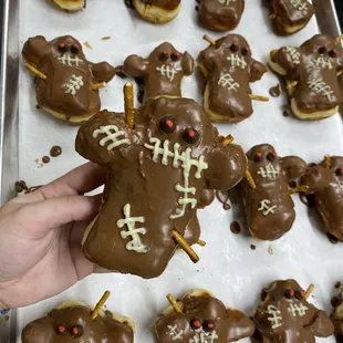 a person holding a chocolate covered cookie