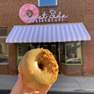 a hand holding a doughnut