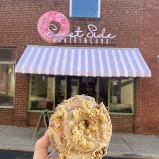 a hand holding a doughnut