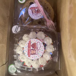 a cookie and a cupcake in a box